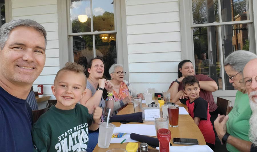 Photo of people getting ready to eat outside on a porch