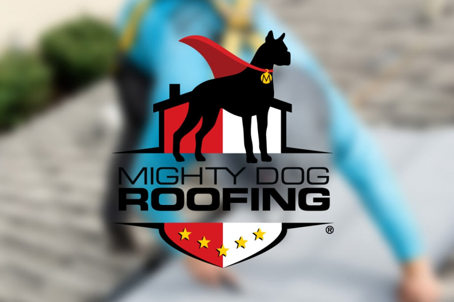 Mighty Dog Roofing Logo - Black dog wearing a red cape illustration above black sans-serif type over blurred photo