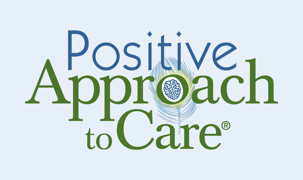 Positive Approach to Care Logo - Blue and green serif type with brain and feather icon on light blue background