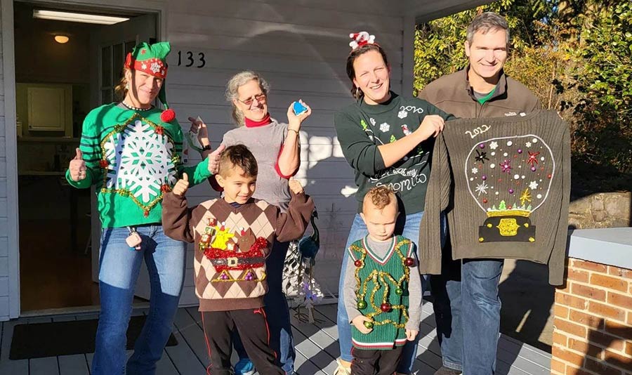 Photo of Snow Approach team wearing Christmas sweaters
