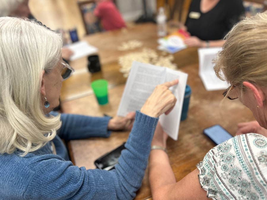 Photo of two women reading a booklet