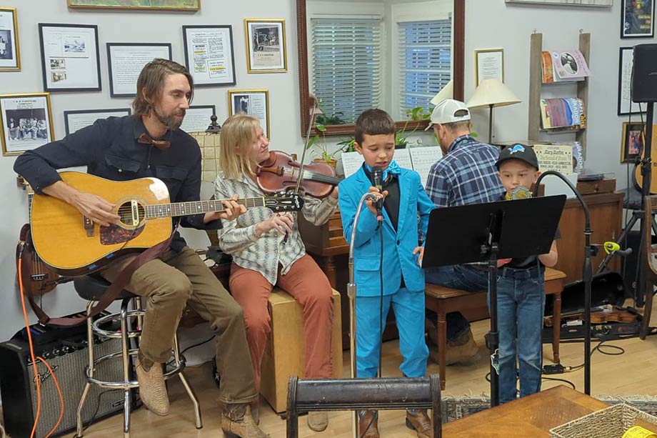 Photo of people singing and playing music