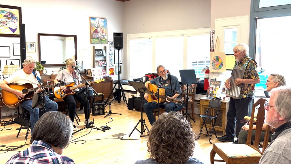 Photo of people singing and playing music